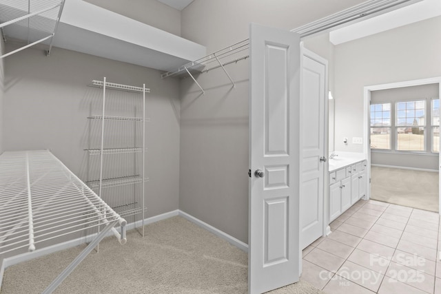 spacious closet with light colored carpet