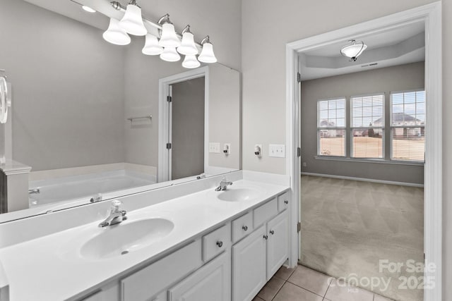 bathroom featuring tile patterned flooring, vanity, and a bathtub