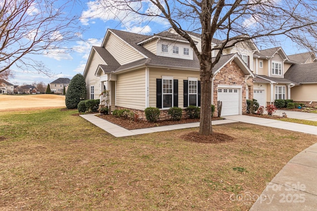 view of front of property with a garage and a front lawn