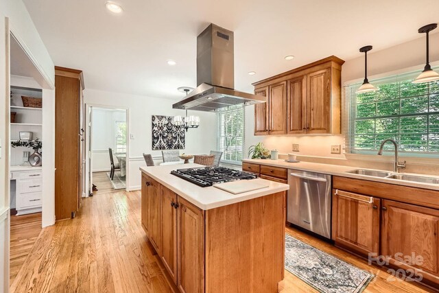 kitchen with a sink, dishwasher, light countertops, black gas cooktop, and island exhaust hood