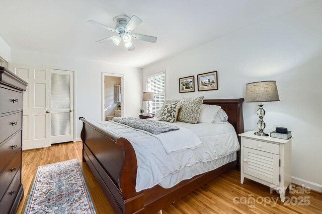 bedroom with baseboards, ceiling fan, light wood-style flooring, and ensuite bathroom