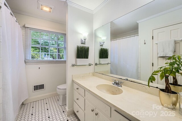 full bath with visible vents, crown molding, baseboards, vanity, and toilet