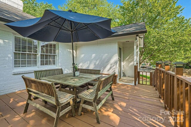 wooden terrace with outdoor dining area