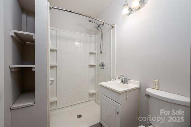 bathroom with walk in shower, vanity, and toilet