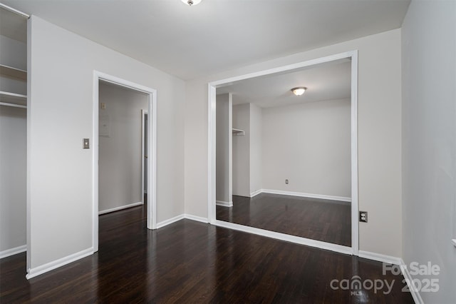 unfurnished bedroom featuring dark hardwood / wood-style floors