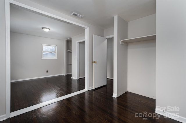 unfurnished bedroom with dark hardwood / wood-style floors