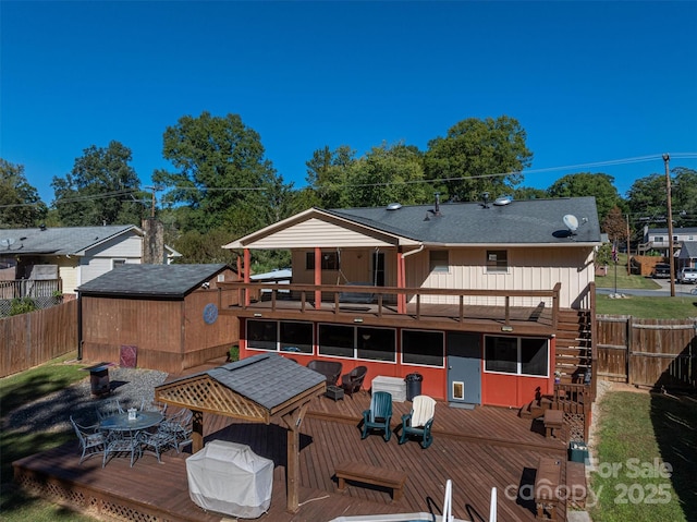 rear view of property featuring a deck