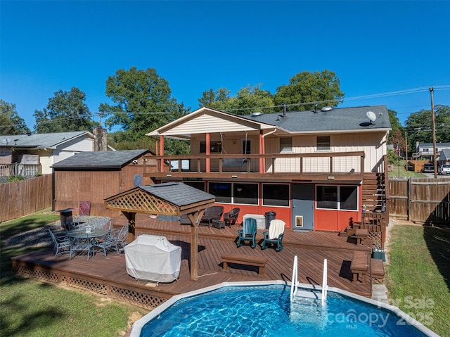 back of property with a balcony and a pool side deck