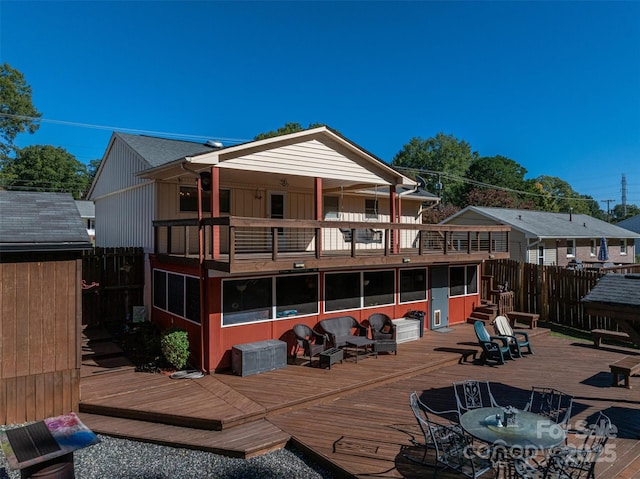 rear view of property featuring a wooden deck