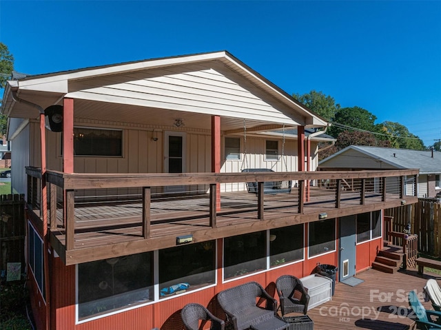 rear view of house featuring a deck