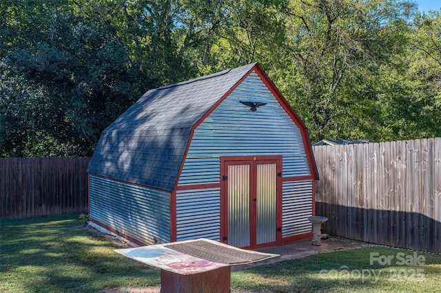 view of outdoor structure featuring a lawn