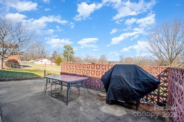 view of patio featuring outdoor dining area and a grill