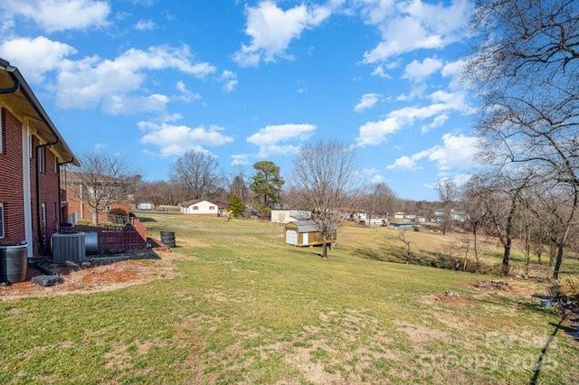 view of yard with a residential view and central AC