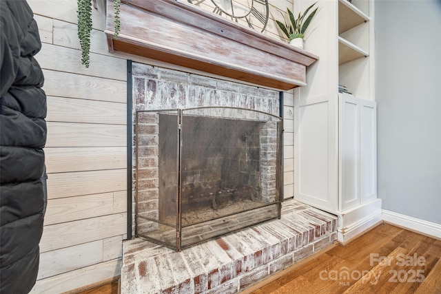 details with hardwood / wood-style floors and a fireplace