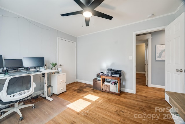 office area with ornamental molding, ceiling fan, and light hardwood / wood-style flooring