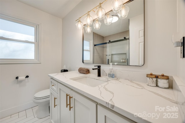 bathroom with vanity, toilet, and a shower with door