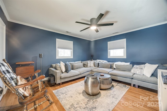 living room with hardwood / wood-style flooring, ceiling fan, and crown molding