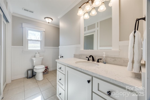 bathroom featuring vanity, ornamental molding, tile patterned floors, and toilet