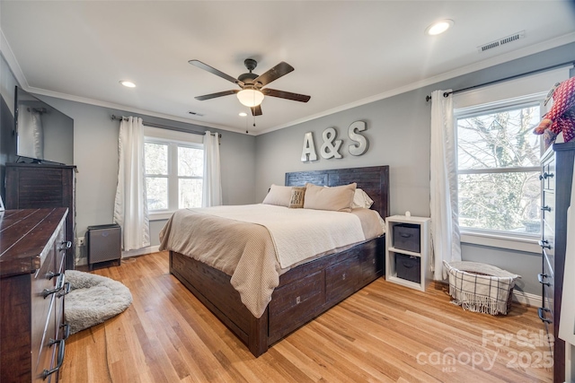 bedroom featuring light hardwood / wood-style flooring, ornamental molding, and ceiling fan