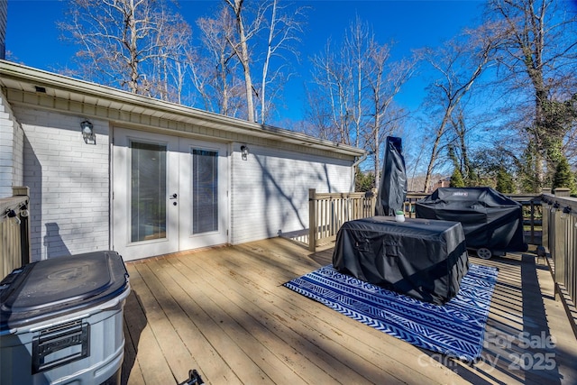 wooden deck featuring a grill