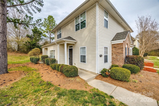 view of property exterior with brick siding