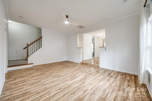 11426 Savannah Creek Dr, Charlotte, NC 28273 - empty room featuring ceiling fan with notable chandelier, light wood finished floors, stairway, and ornamental molding