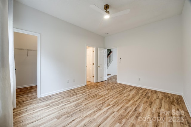11426 Savannah Creek Dr, Charlotte, NC 28273 - unfurnished bedroom with a ceiling fan, baseboards, light wood-style floors, a spacious closet, and a closet