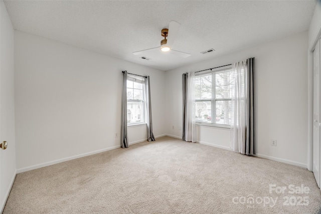 11426 Savannah Creek Dr, Charlotte, NC 28273 - carpeted spare room with a ceiling fan, visible vents, a textured ceiling, and baseboards