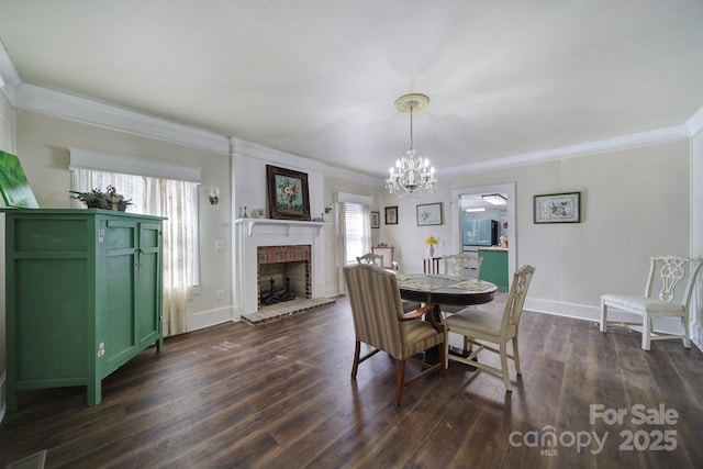 dining space with crown molding, a brick fireplace, a notable chandelier, and dark hardwood / wood-style floors