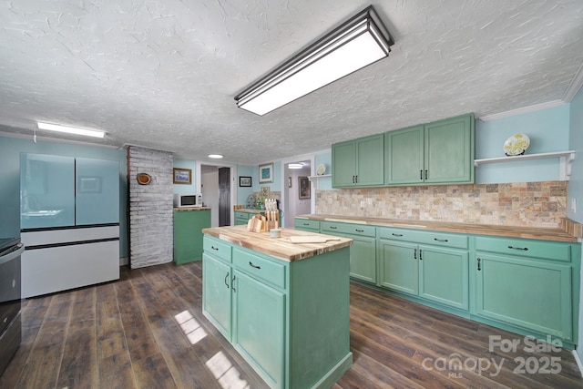 kitchen featuring dark wood-type flooring, a kitchen island, wood counters, and green cabinets