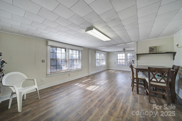 dining space with crown molding and dark hardwood / wood-style floors