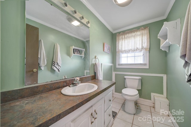 bathroom with vanity, crown molding, tile patterned flooring, and toilet