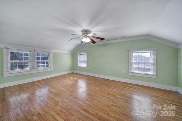 bonus room featuring lofted ceiling, hardwood / wood-style flooring, and ceiling fan