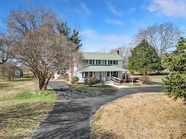 view of front of property with a front yard and covered porch