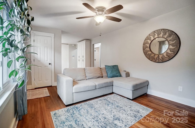 living room featuring dark hardwood / wood-style floors and ceiling fan