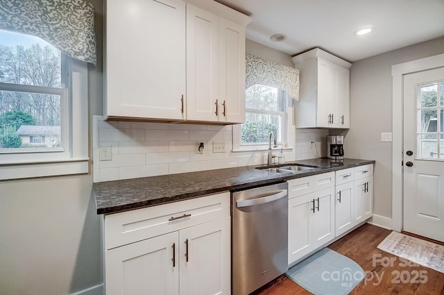 kitchen featuring sink, white cabinetry, dark hardwood / wood-style floors, dishwasher, and a wealth of natural light