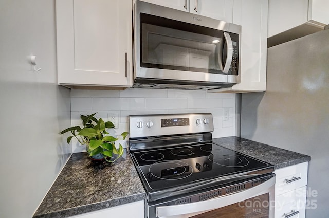 kitchen with white cabinetry, tasteful backsplash, and stainless steel appliances