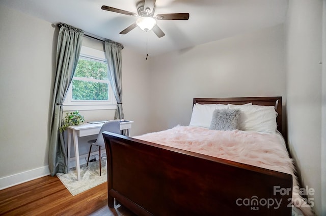 bedroom featuring wood-type flooring and ceiling fan