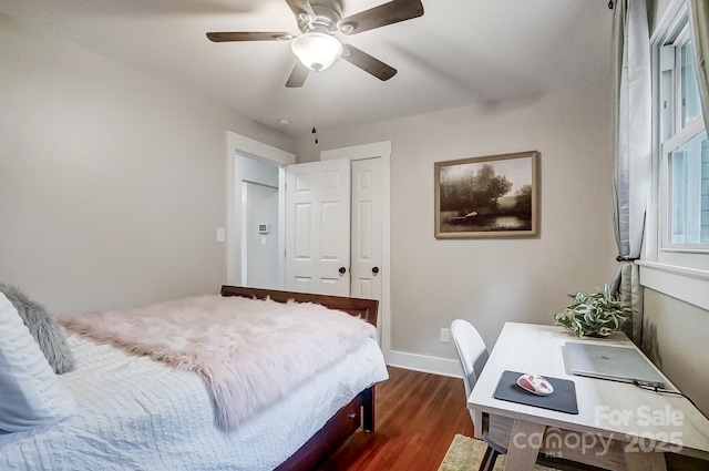 bedroom with ceiling fan and dark hardwood / wood-style flooring