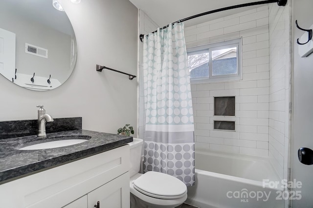 full bathroom featuring vanity, shower / tub combo, and toilet