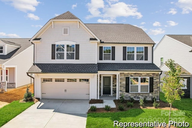 craftsman-style house featuring a garage and a front lawn