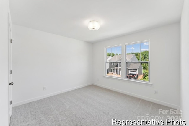 empty room featuring light carpet