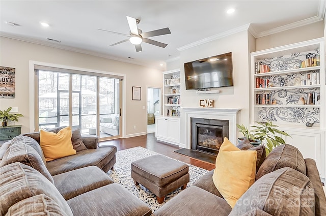 14827 Batteliere Dr, Charlotte, NC 28278 - living area featuring recessed lighting, ornamental molding, dark wood-style flooring, and a glass covered fireplace