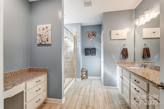 14827 Batteliere Dr, Charlotte, NC 28278 - bathroom featuring vanity, visible vents, baseboards, a shower stall, and wood tiled floor