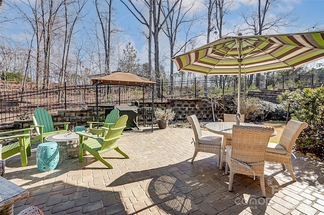 14827 Batteliere Dr, Charlotte, NC 28278 - view of patio with fence, a fire pit, outdoor dining area, and a gazebo