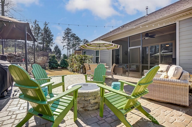 14827 Batteliere Dr, Charlotte, NC 28278 - view of patio with ceiling fan, an outdoor fire pit, and a sunroom