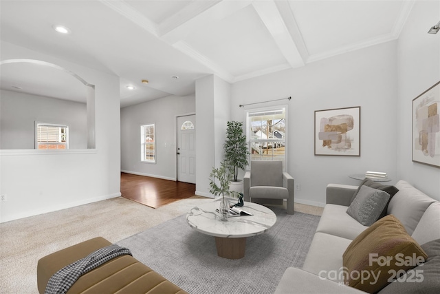 living room with light carpet, beam ceiling, and plenty of natural light