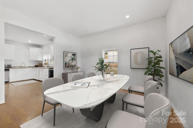 dining area with sink and light hardwood / wood-style flooring