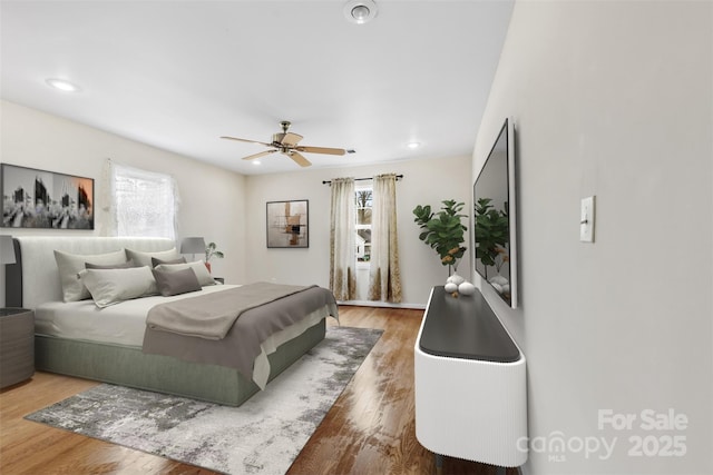 bedroom with hardwood / wood-style floors and ceiling fan