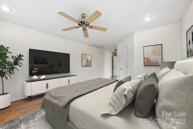 bedroom with hardwood / wood-style flooring and ceiling fan